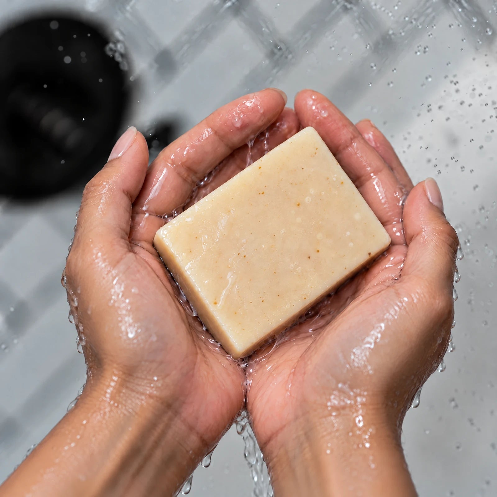 Remainder Bergamot Tangerine tallow bar soap: in the hands under water