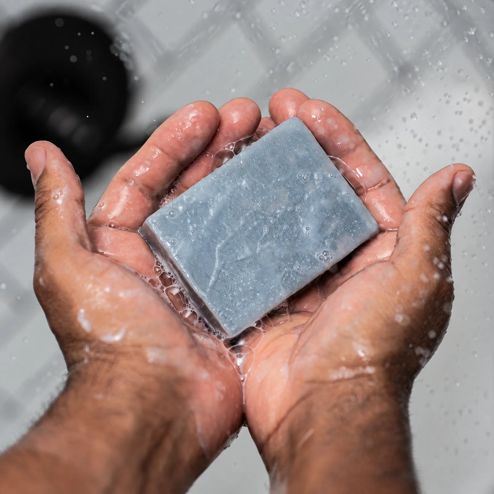Remainder Eucalyptus Charcoal tallow bar soap: in the hands under water