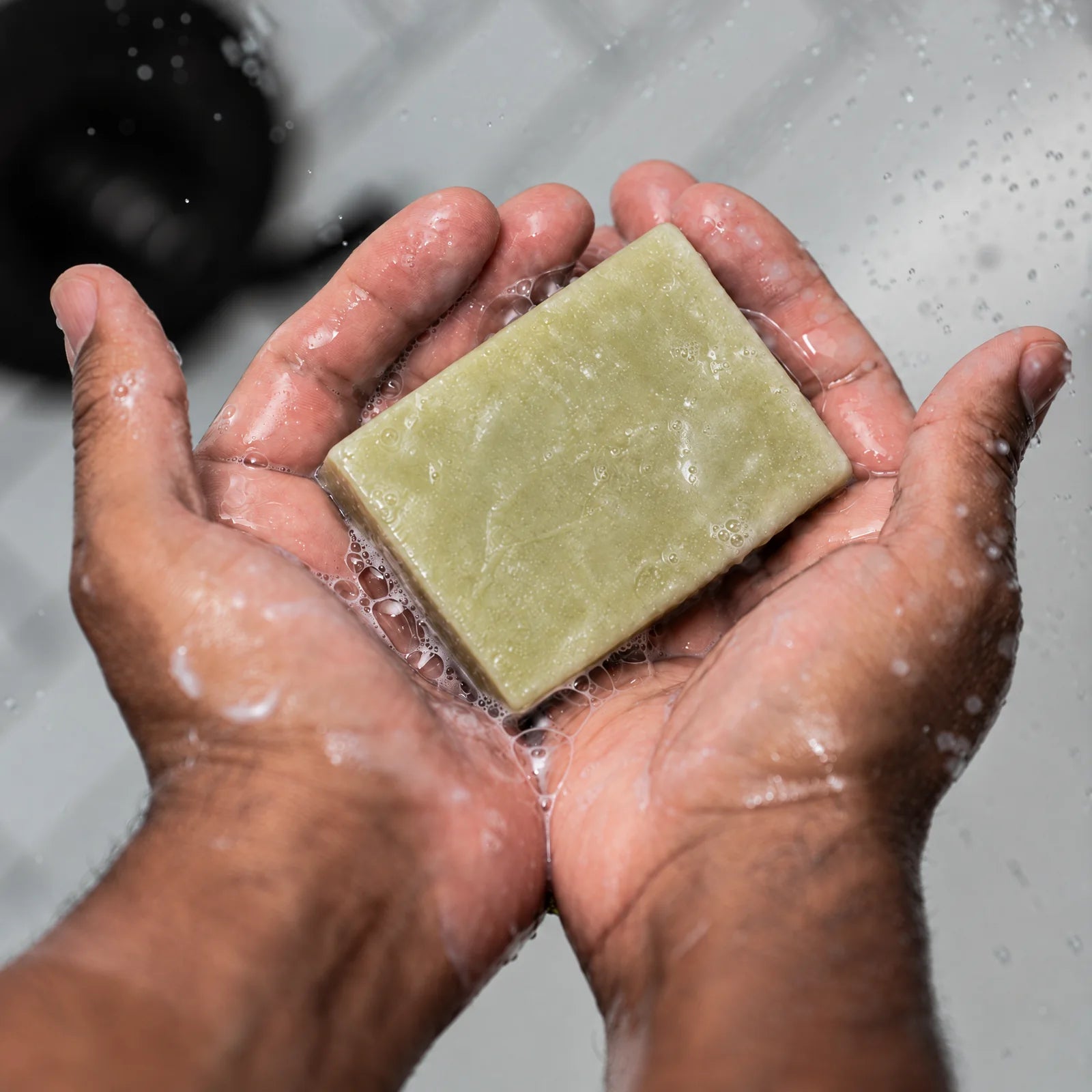 Remainder Pine Cedarwood tallow bar soap: in the hands under water